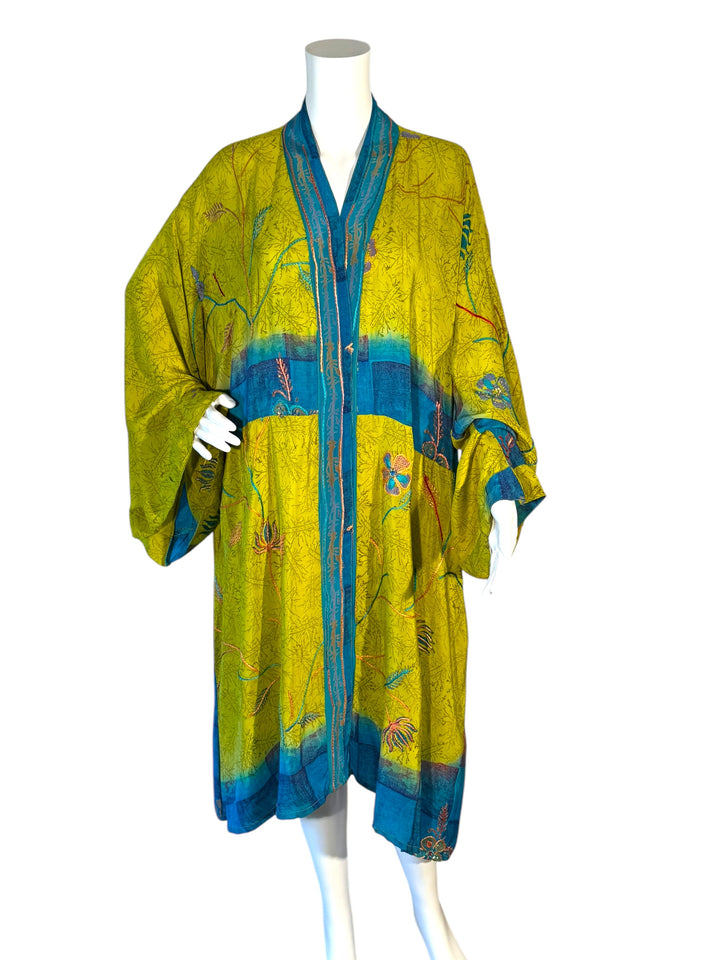Front view of unisex kimono in bright yellow-green with blue and floral embroidery