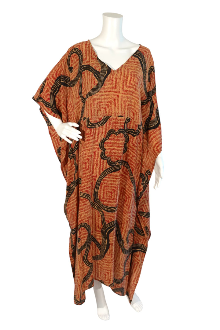 Red and black patterned vintage silk kaftan on a mannequin against a white background