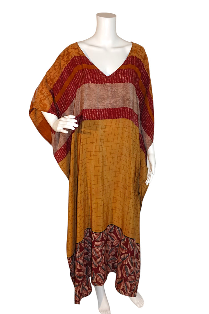 Mannequin wearing a long, patterned Silk Ranch vintage silk kaftan in gold and red and orange