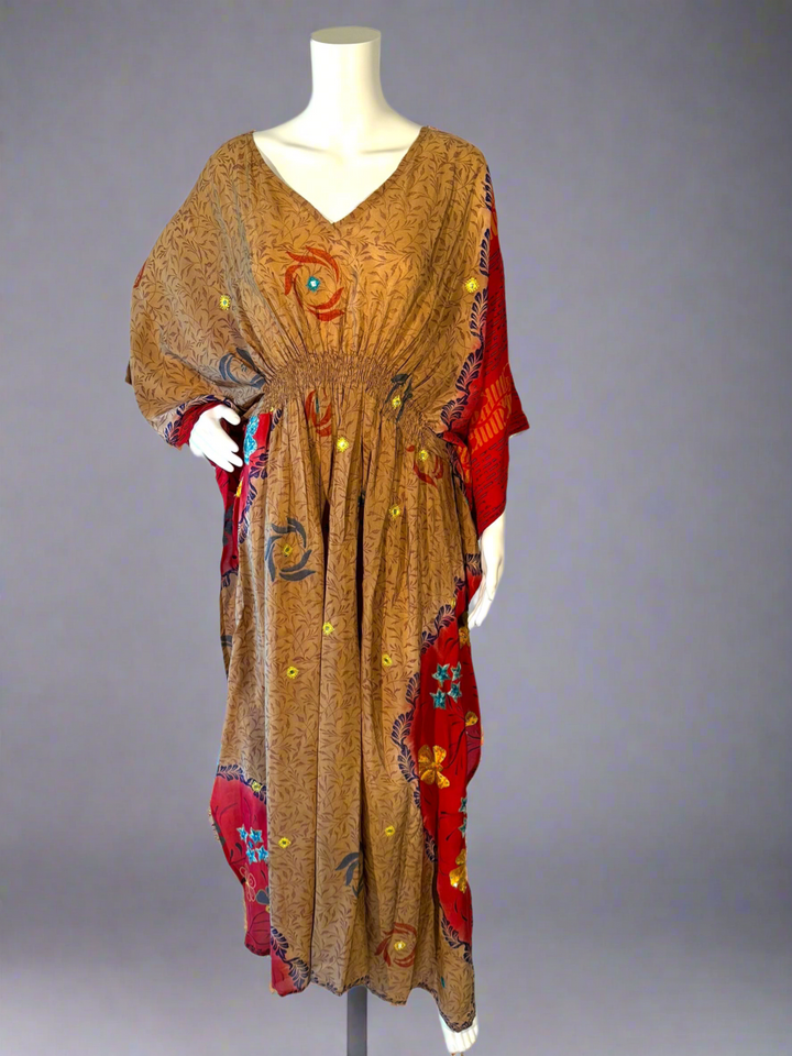 Mannequin wearing a vintage silk kaftan with a mix of colors on a gray background