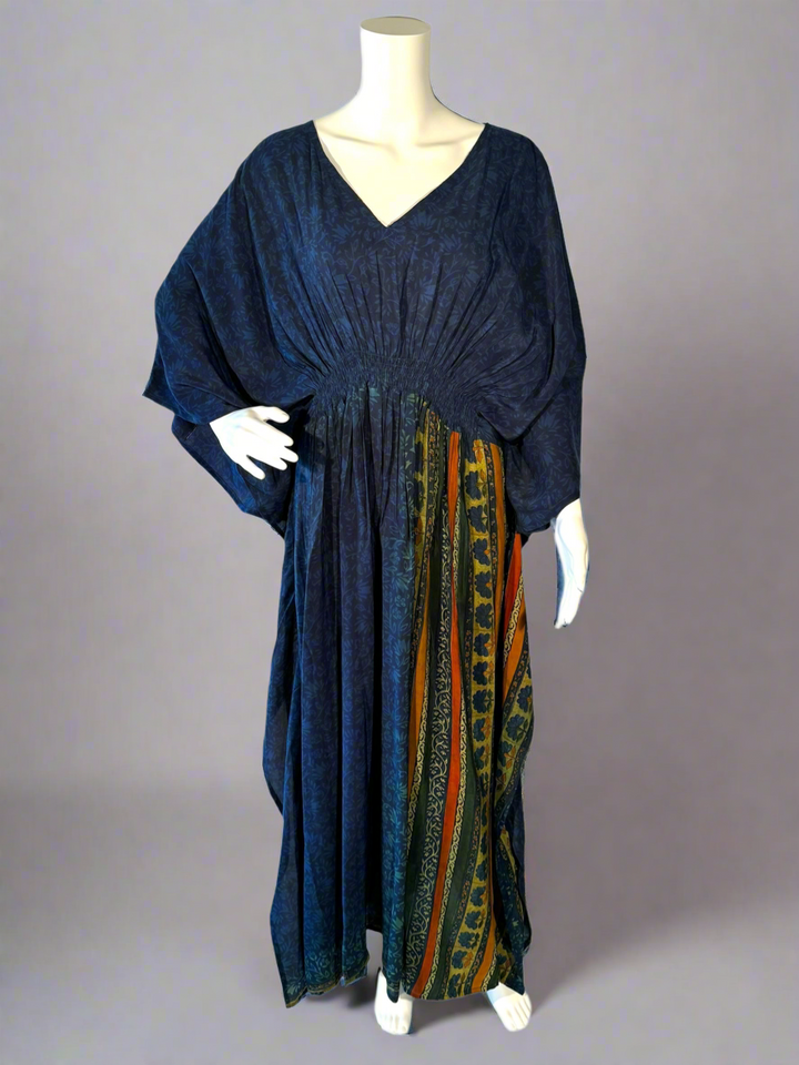 Navy blue vintage silk kaftan with a patterns on a mannequin against a gray background