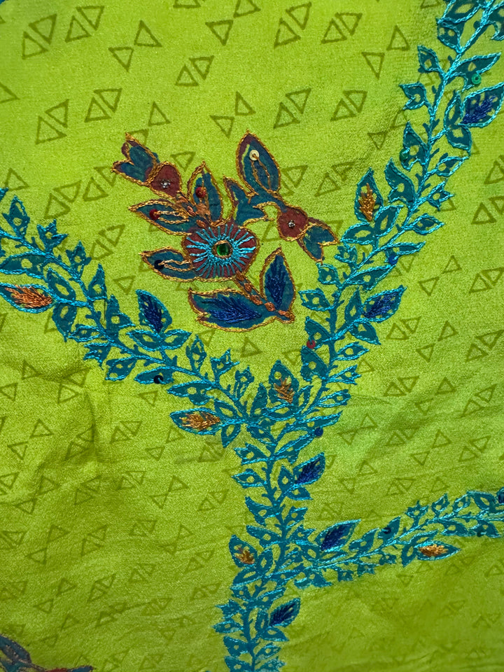 Detail view of vintage silk Willow Wrap in green and blue  with extensive floral embroidery