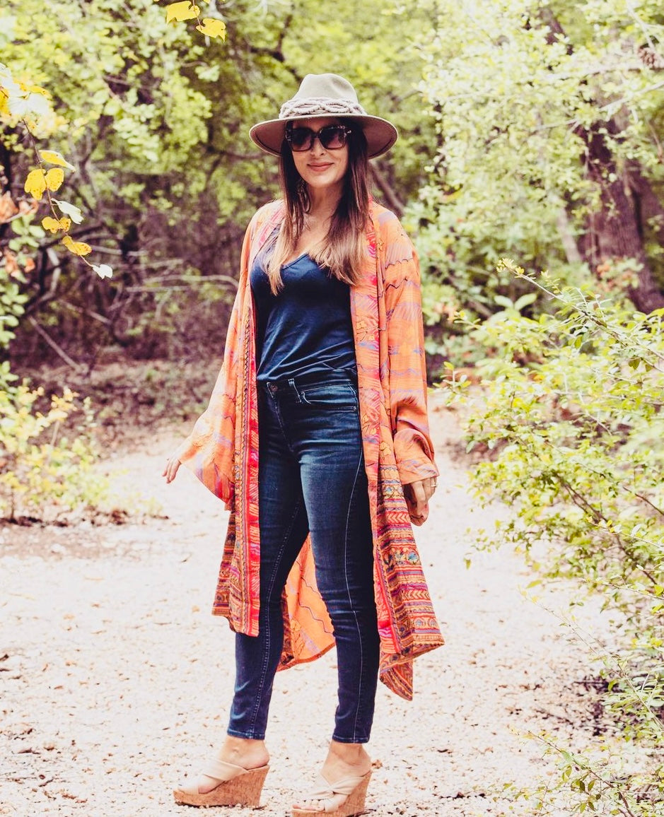 Colorful kimonos in vintage Indian silk.  Model styled in orange silk and wearing jeans and hat