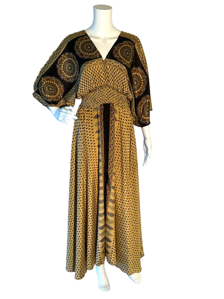 Cream and black paisley print boho silk blend dress.  Midi length with V neck front and back and tassel tie.  Flattering elastic gathering under bust.