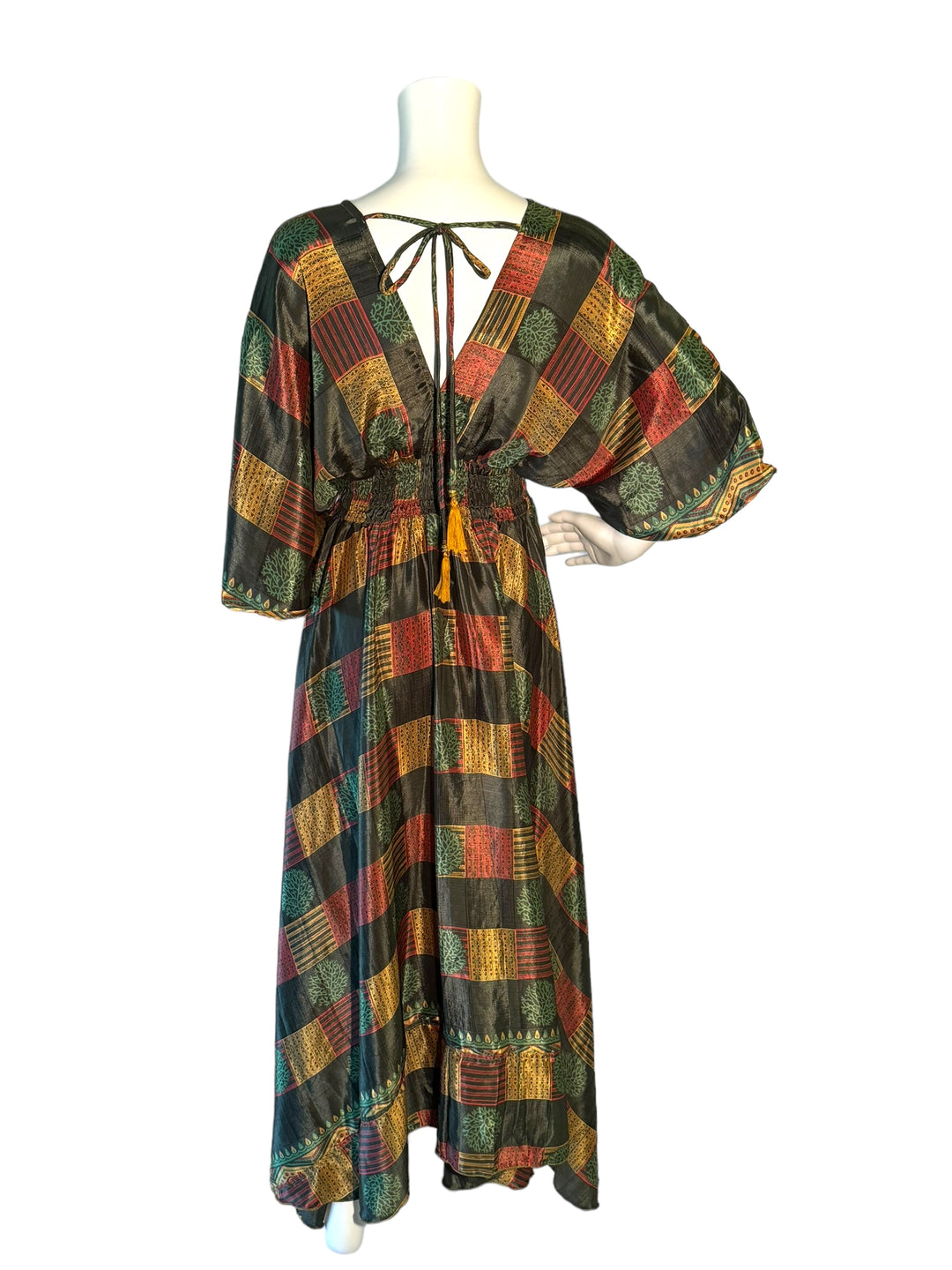 Reverse view of dark green, red and gold print Boho dress in sustainable silk blend.