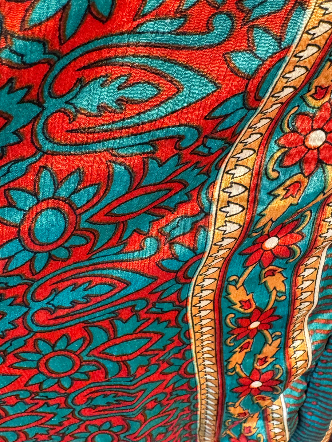 Red and teal floral print on sustainable silk blend dress.