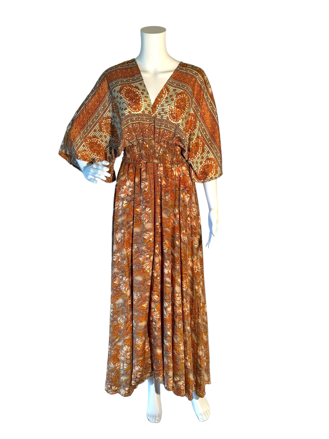 Rust, orange and cream floral print boho silk blend dress.  Midi length with V neck front and back and tassel tie.  Flattering elastic gathering under bust.