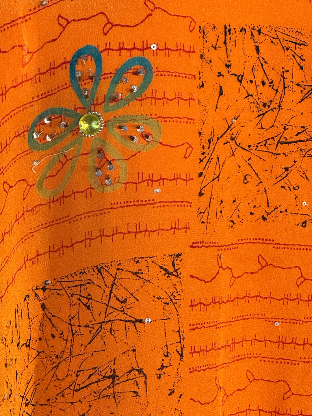 Orange vintage silk with patterns and green flower and gold sequins