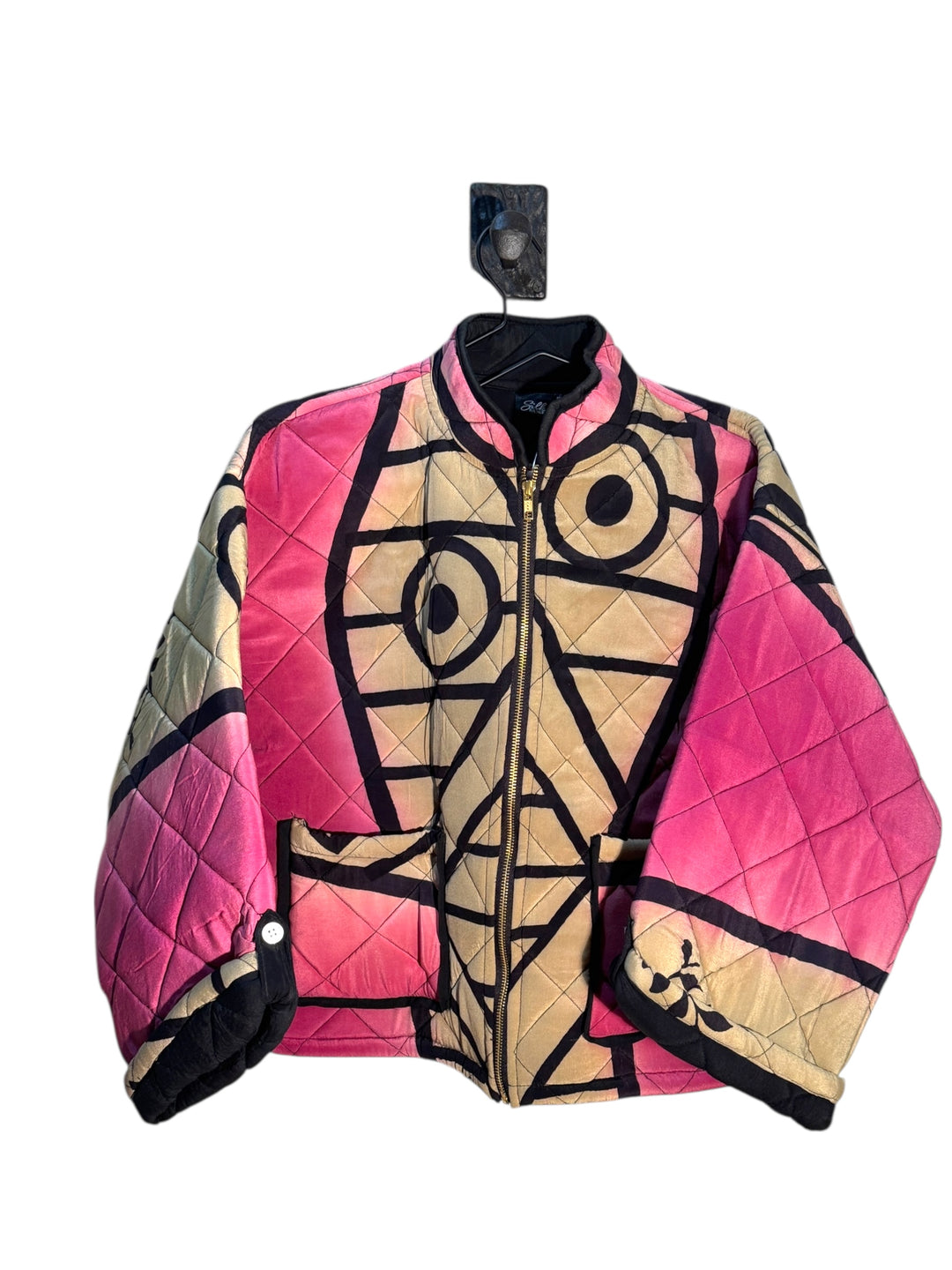 Quilted silk  jacket with geometric pattern on a white background