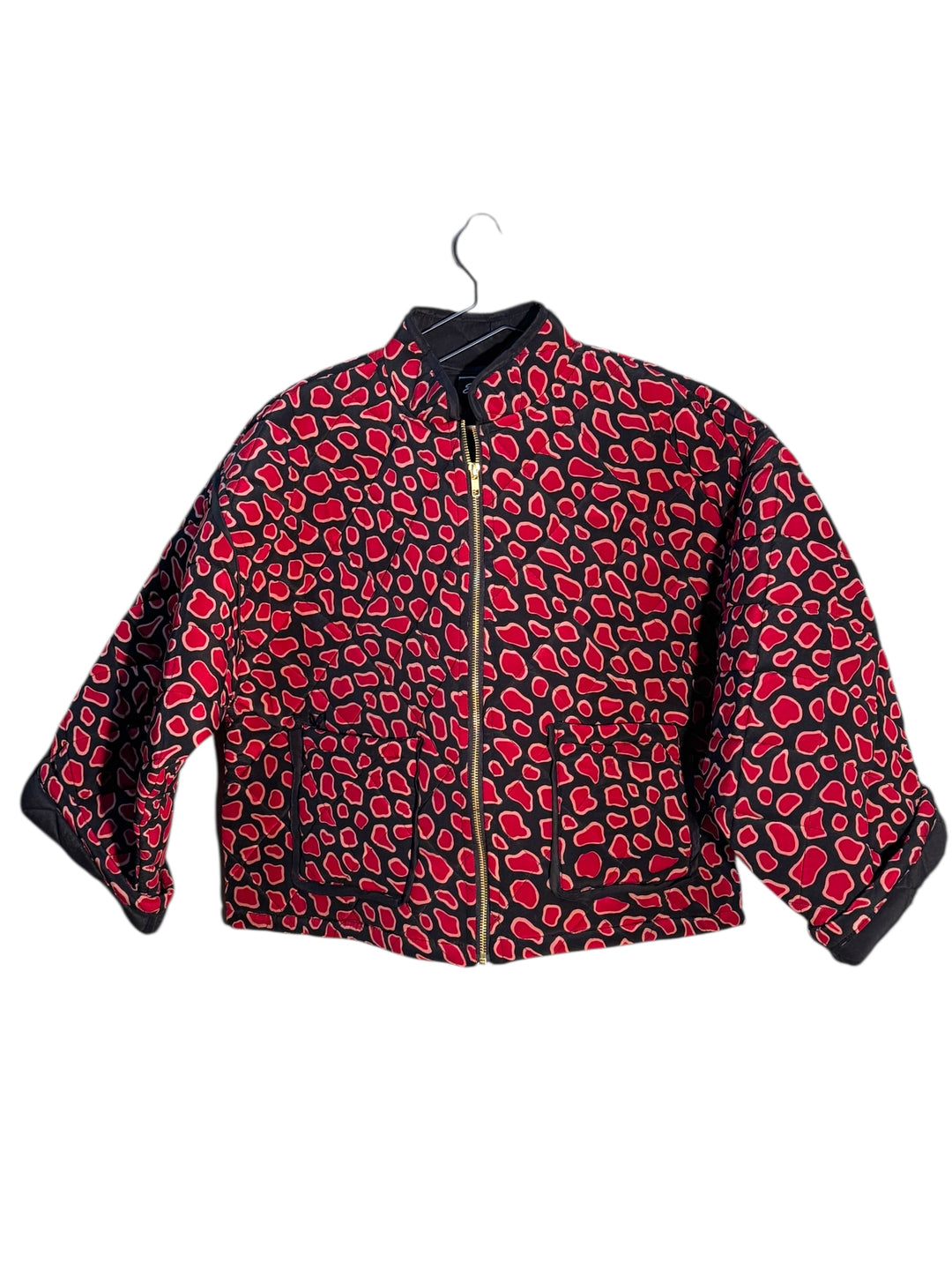 Red and black patterned  quilted silk jacket on a white background