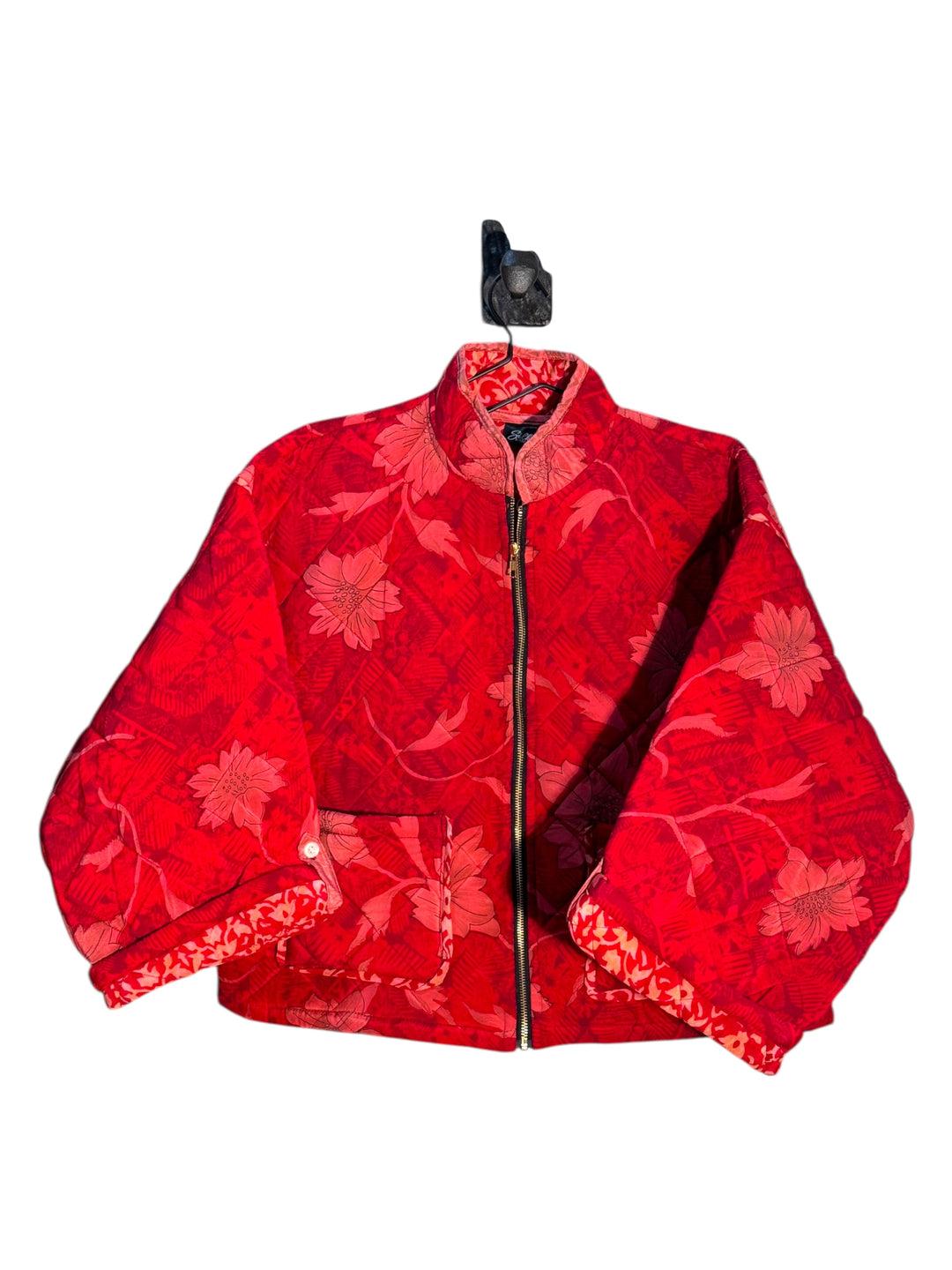 Red floral-patterned quilted silk  jacket on a white background