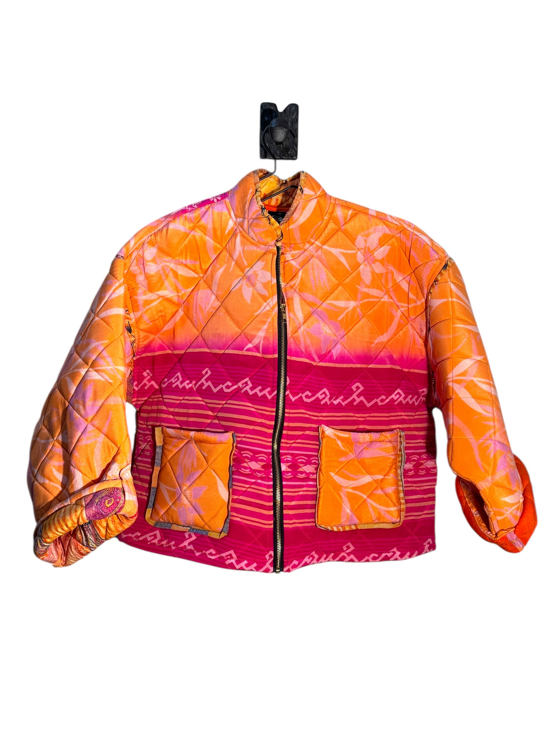 Quilted  silk jacket with pink and orange pattern on a white background