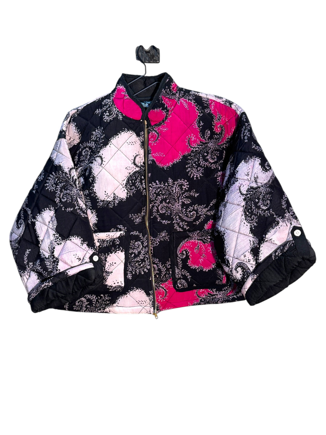 Patterned jacket with pink and white and black silk quilt design on a white background