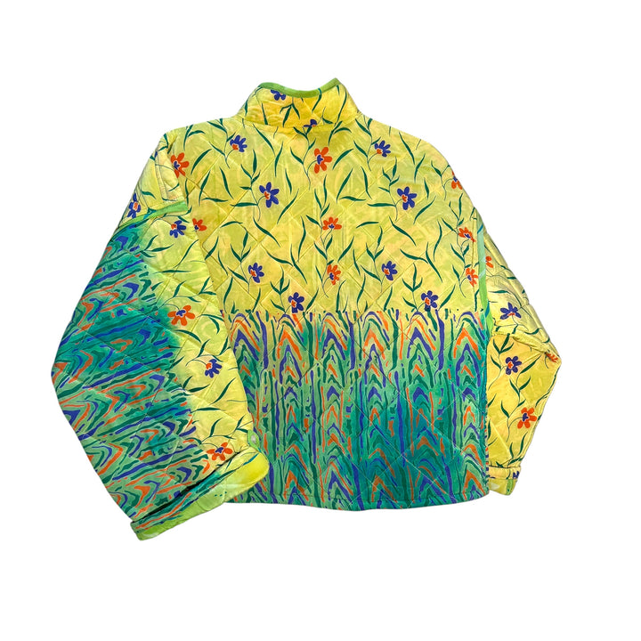 Colorful floral-patterned quilted silk jacket on a white background
