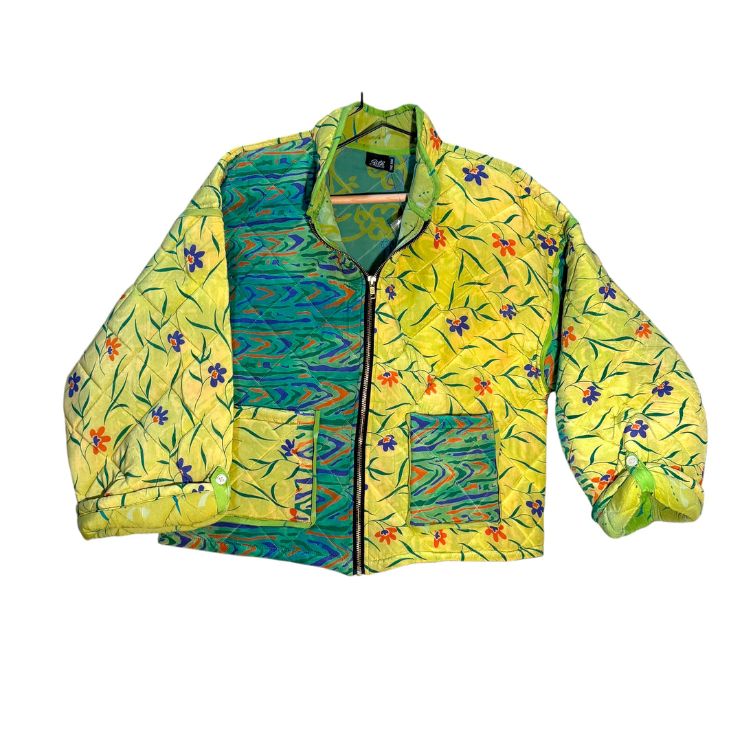Colorful quilted silk jacket with floral pattern on a white background