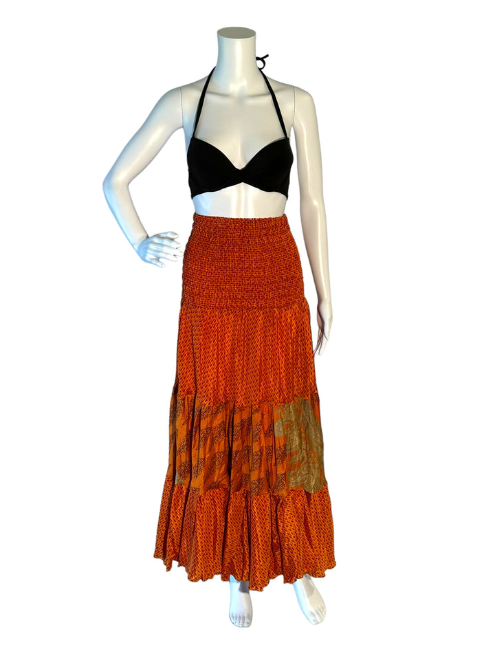 Orange multi print maxi skirt in gathered tiers.  Wide elastic top can become a strapless dress.  Recycled Indian silks.