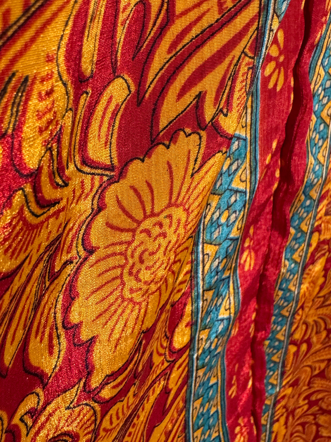 Red, yellow and teal print on sustainable silk blend dress.