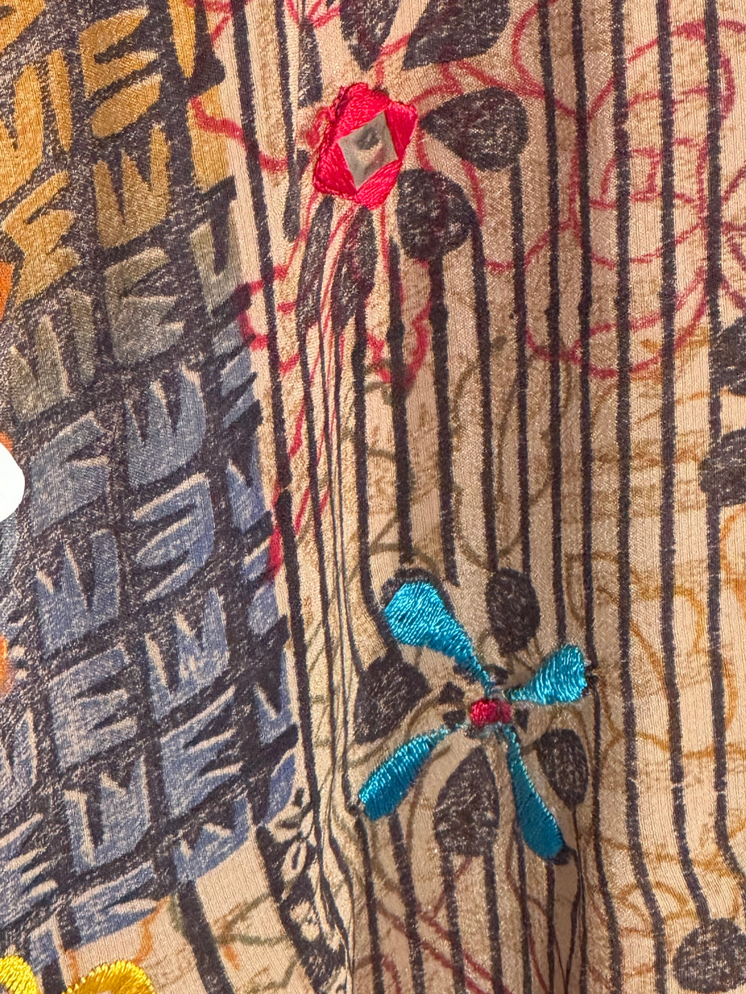 Ivy Kaftan by Silk Ranch in tan patterned vintage silk with yellow, red and bllue flowers  and mirrored sequins, fabric detail 1