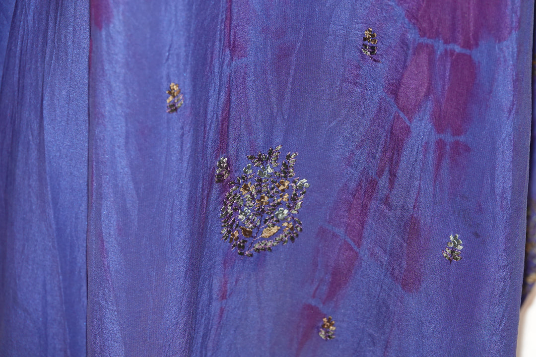 Close-up of a blue dip dyed vintage silk with embroidered floral patterns