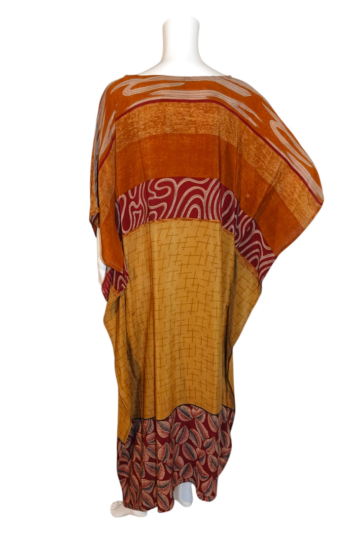Red and orange patterned vintage silk kaftan on a white mannequin with a white background