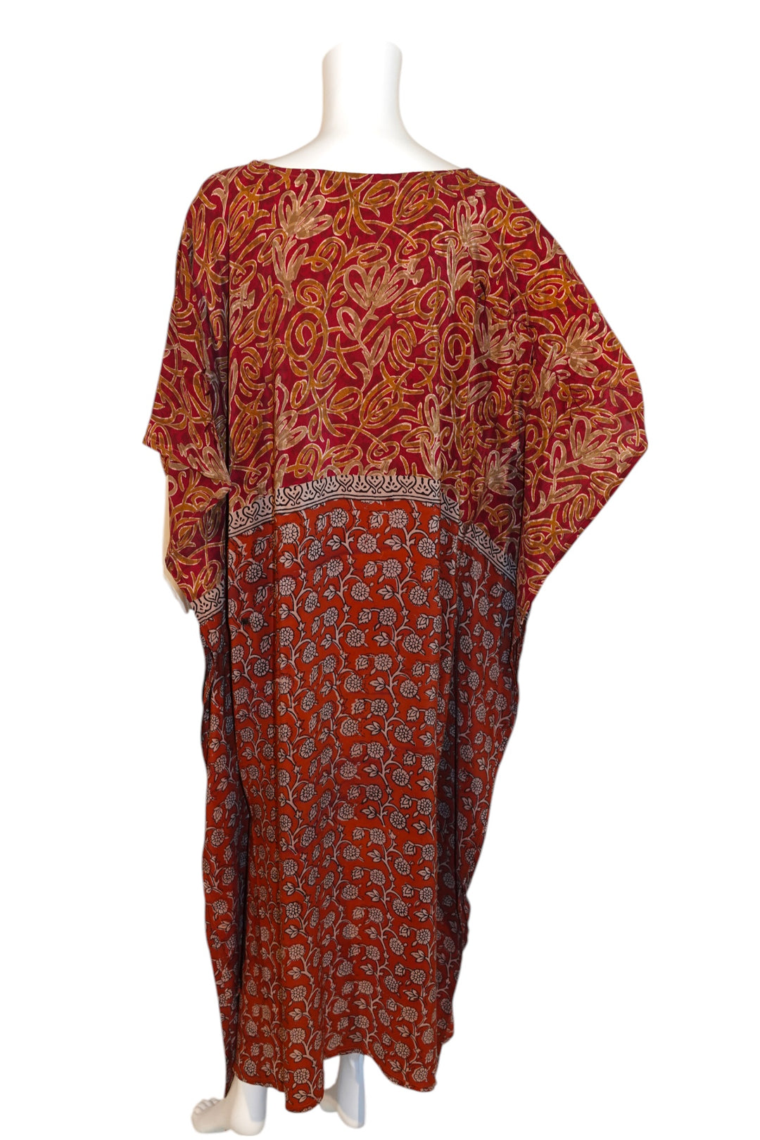 Red patterned vintage silk kaftan on a mannequin against a white background