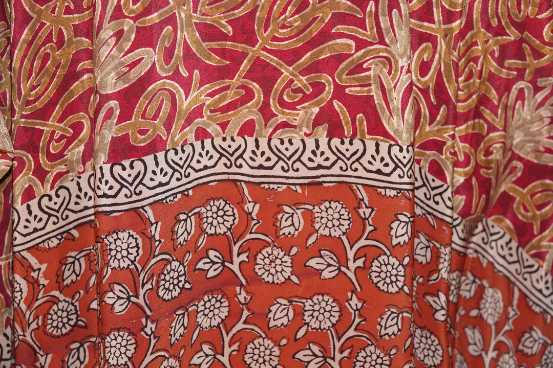 Close-up of vintage silk with red, gold, and white floral patterns