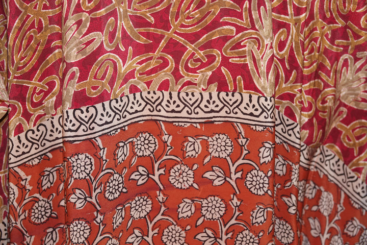 Close-up of vintage silk with red, gold, and white floral patterns