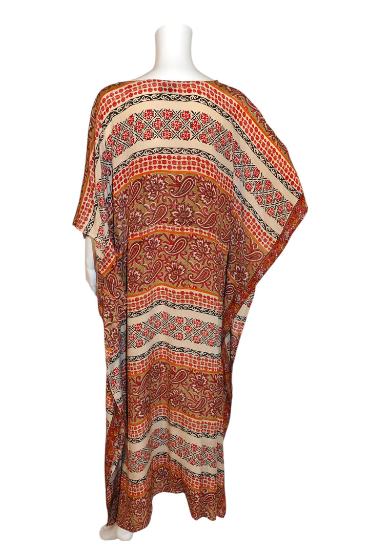 Patterned vintage silk kaftan in orange and red on a mannequin against a white background