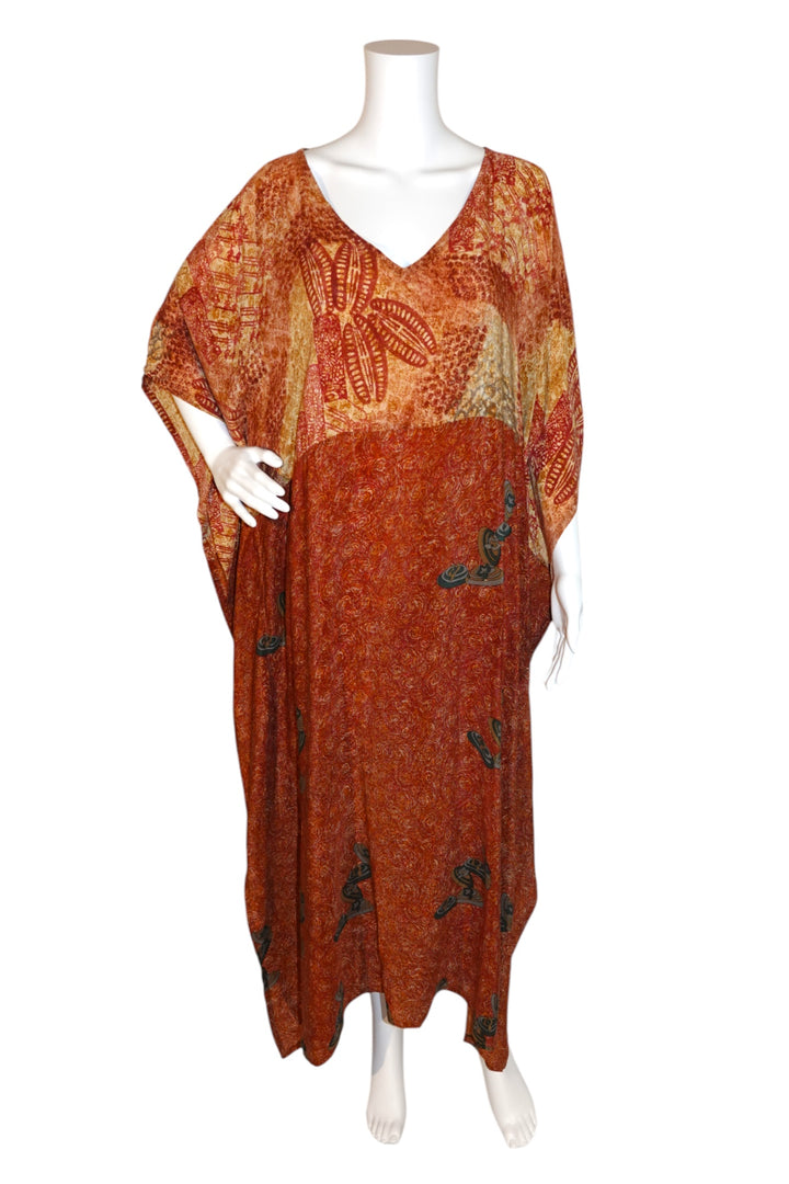 Orange and red patterned vintage silk kaftan on a mannequin against a white background