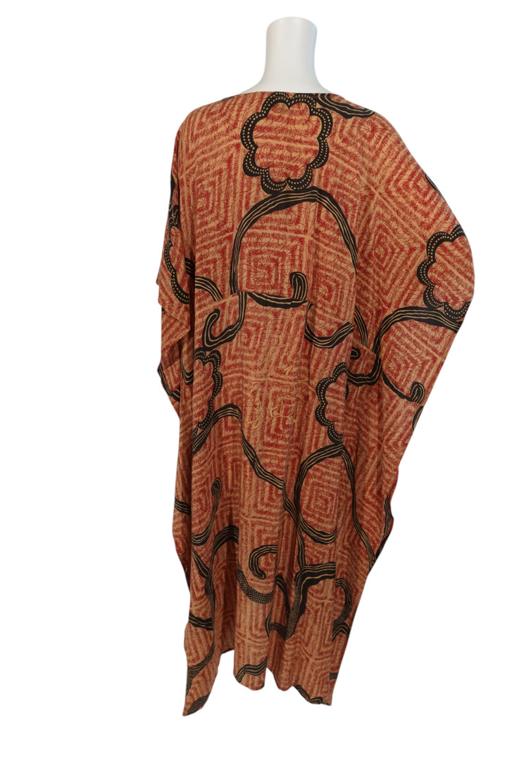 Red and black  patterned vintage silk kaftan on a mannequin against a white background