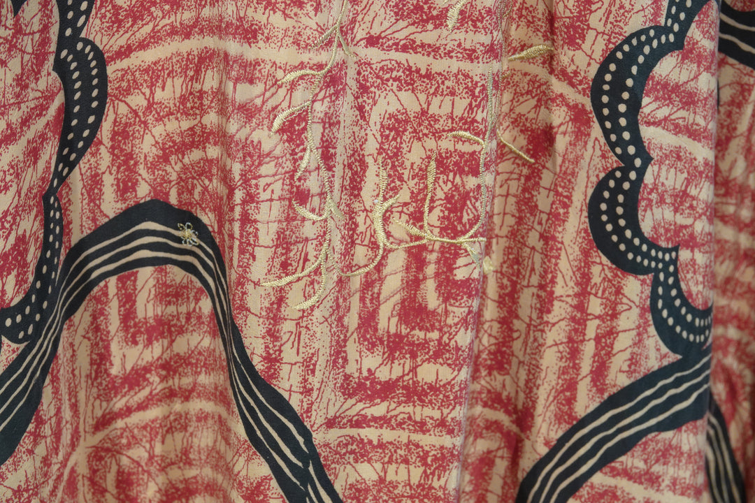Close-up of vintage silk  with red and black pattern and embroidery