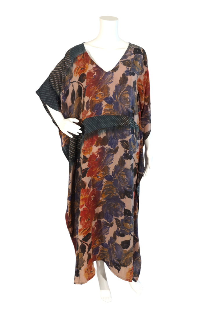 Colorful floral vintage silk kaftan on a mannequin against a white background