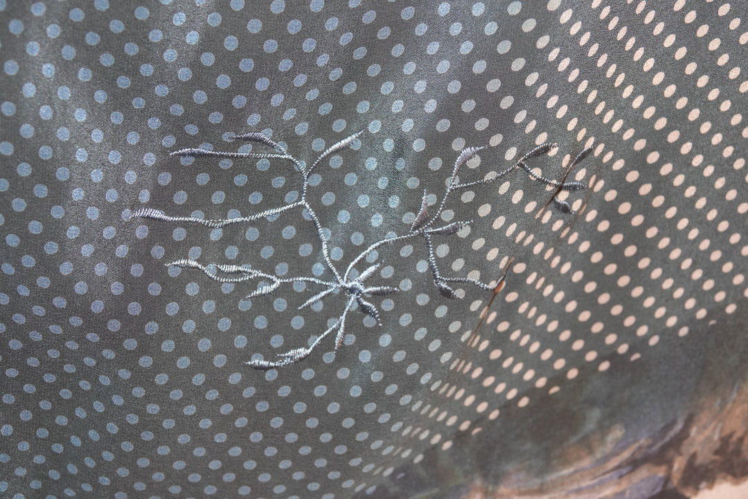 Embroidered design on vintage silk kaftan with a polka dot pattern