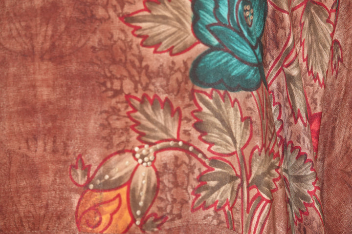 Close-up of a vintage silk with floral patterns on a brown background
