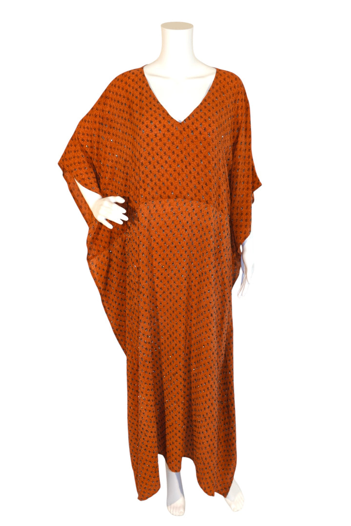 Orange sequined vintage silk kaftan on a mannequin against a white background