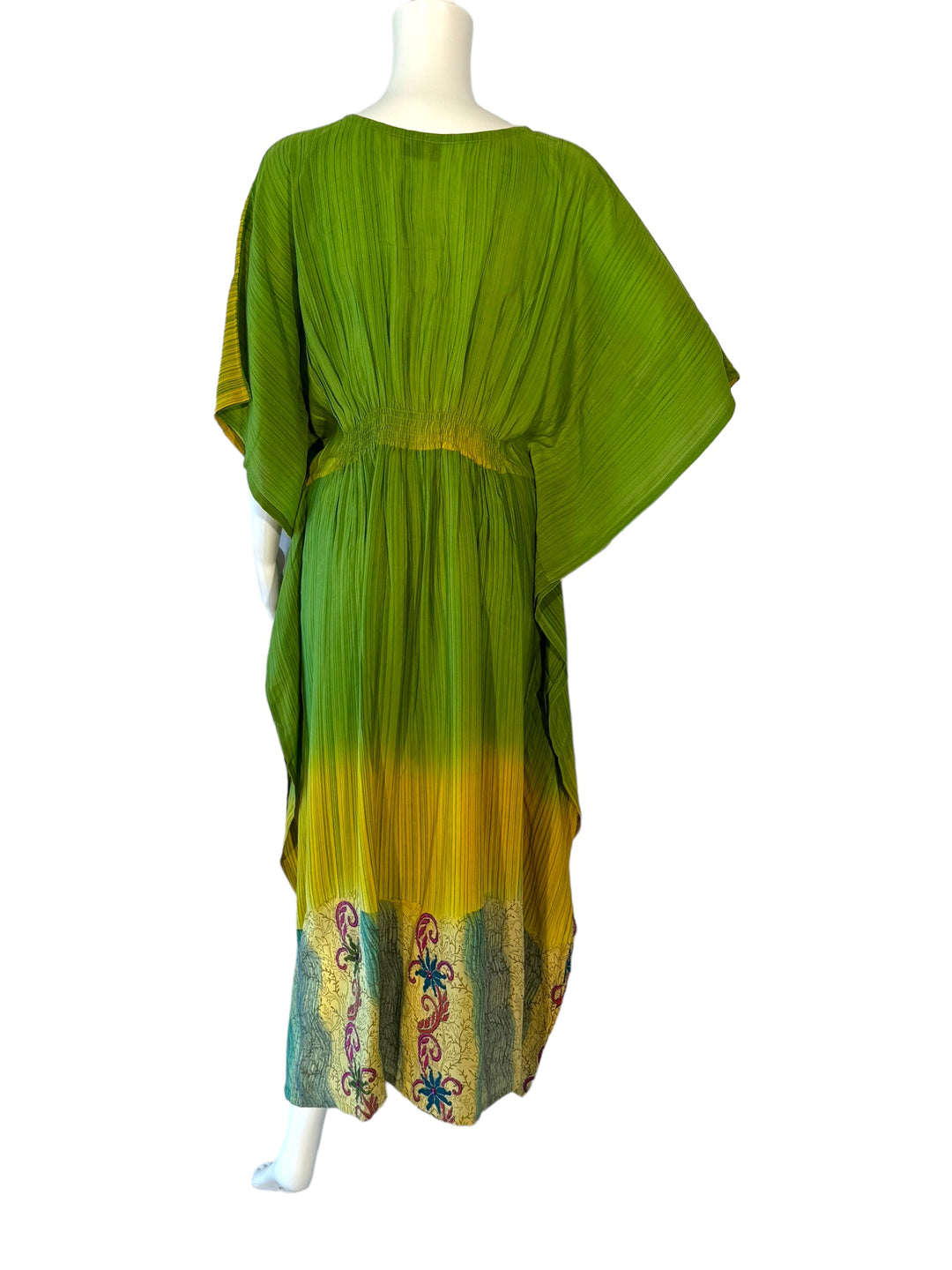 Back view of SM vintage silk kaftan in green and yellow with bright embroidered
flowers and jewels