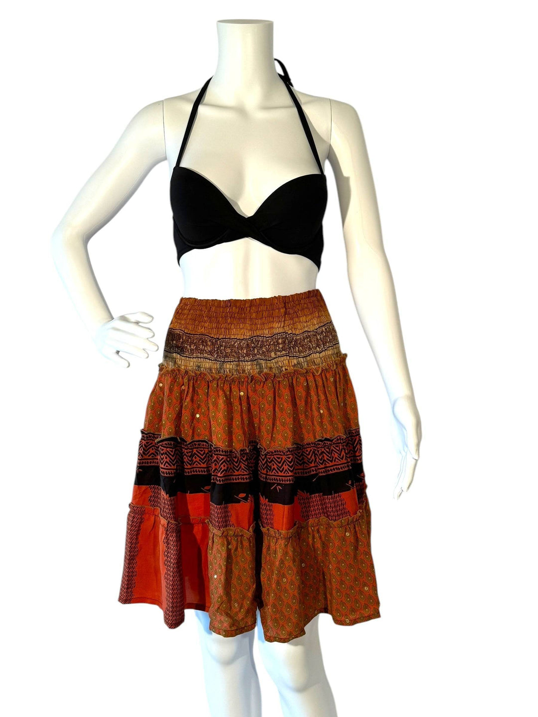 Mannequin wearing gather elastic waist vintage silk tiered skirt in orange with black and gold print