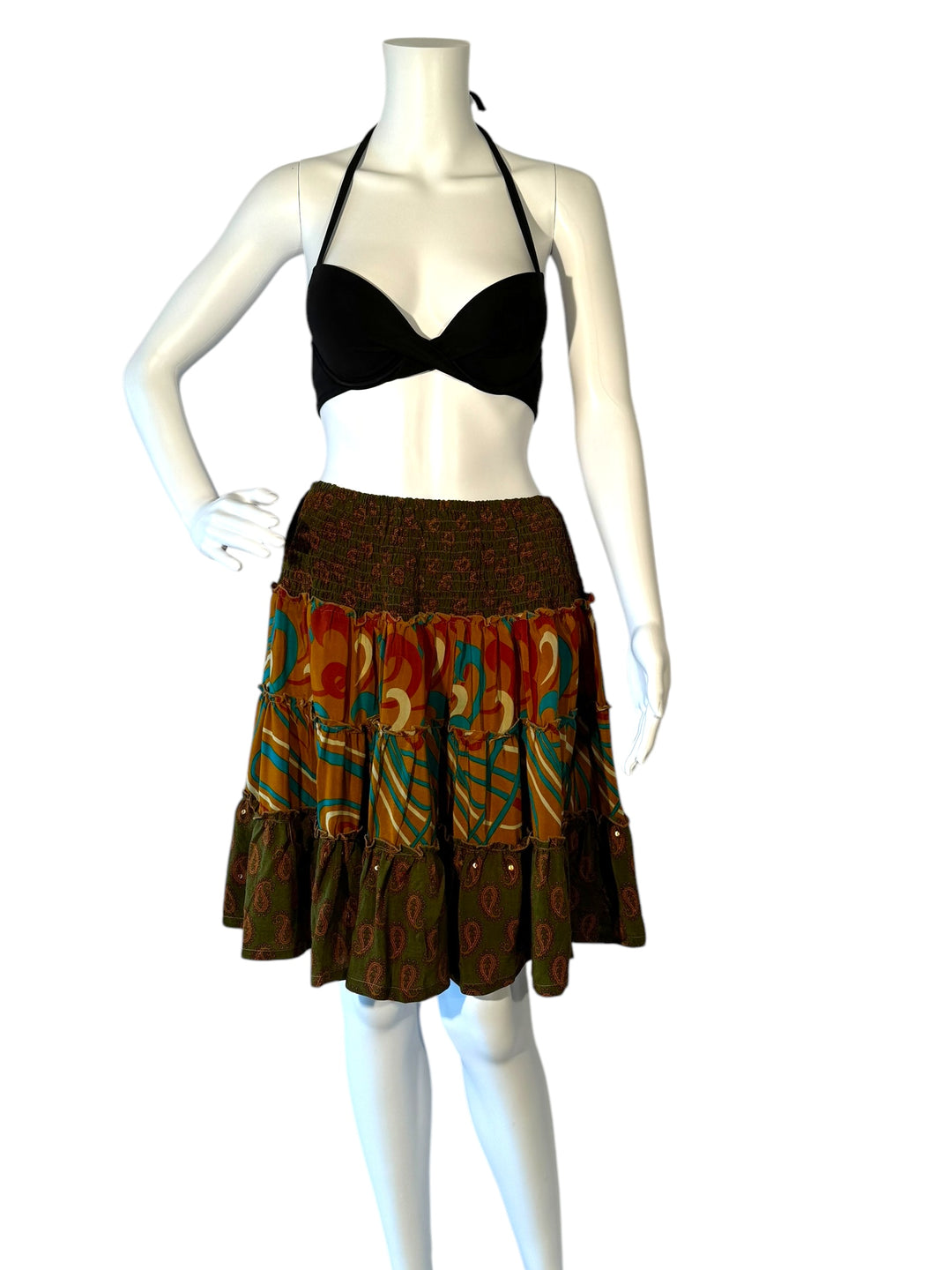 Mannequin wearing vintage silk gathered elastic short tiered skirt in rbrown with ed blue graphic and green paisley prints