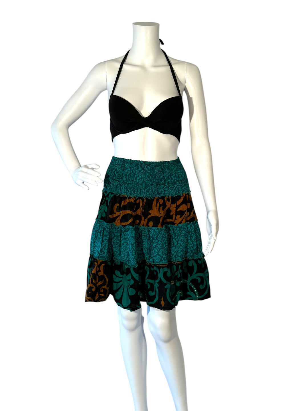 Mannequin wearing vintage silk gathered elastic short tiered skirt in blue green with dark brown print