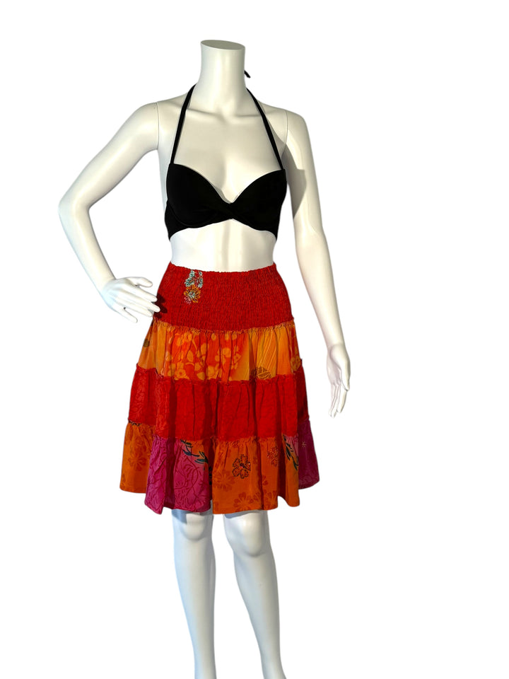 Mannequin wearing vintage silk gathered elastic short tiered skirt in  orange floral print and embroidery