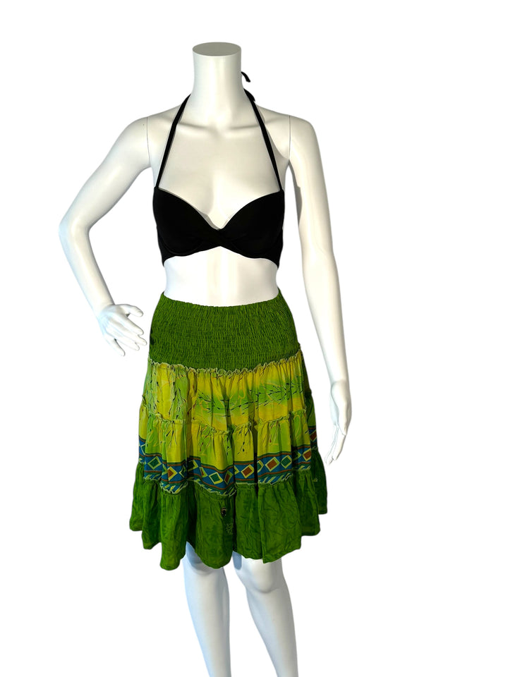 Mannequin wearing vintage silk gathered elastic short tiered skirt in green with red and blue border print