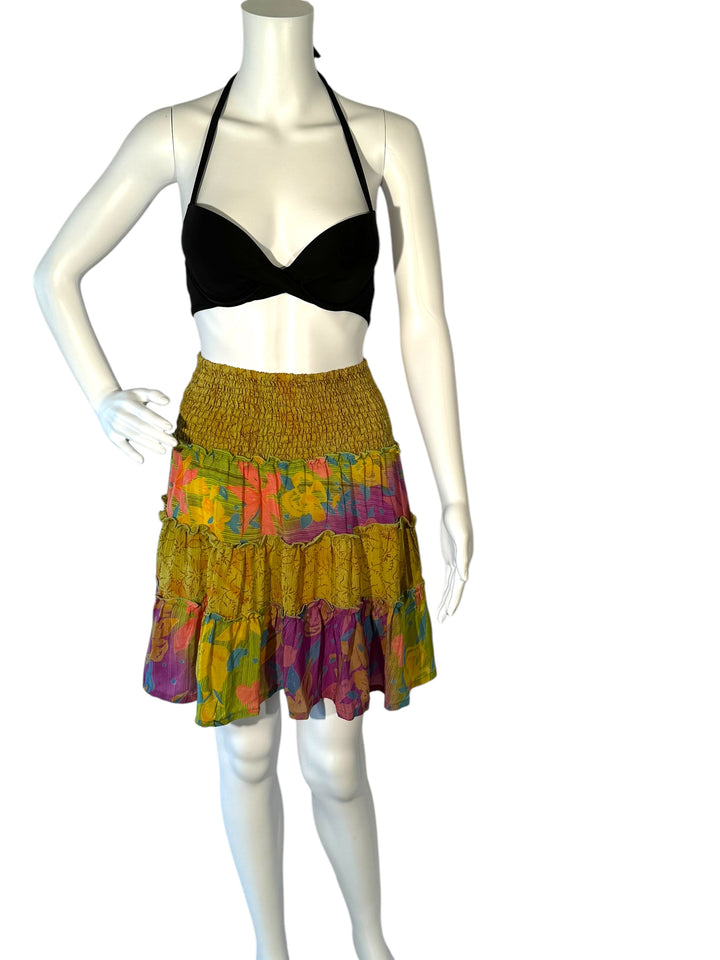 Mannequin wearing vintage silk gathered elastic short tiered skirt in yellow  with bright orange and purple flowers