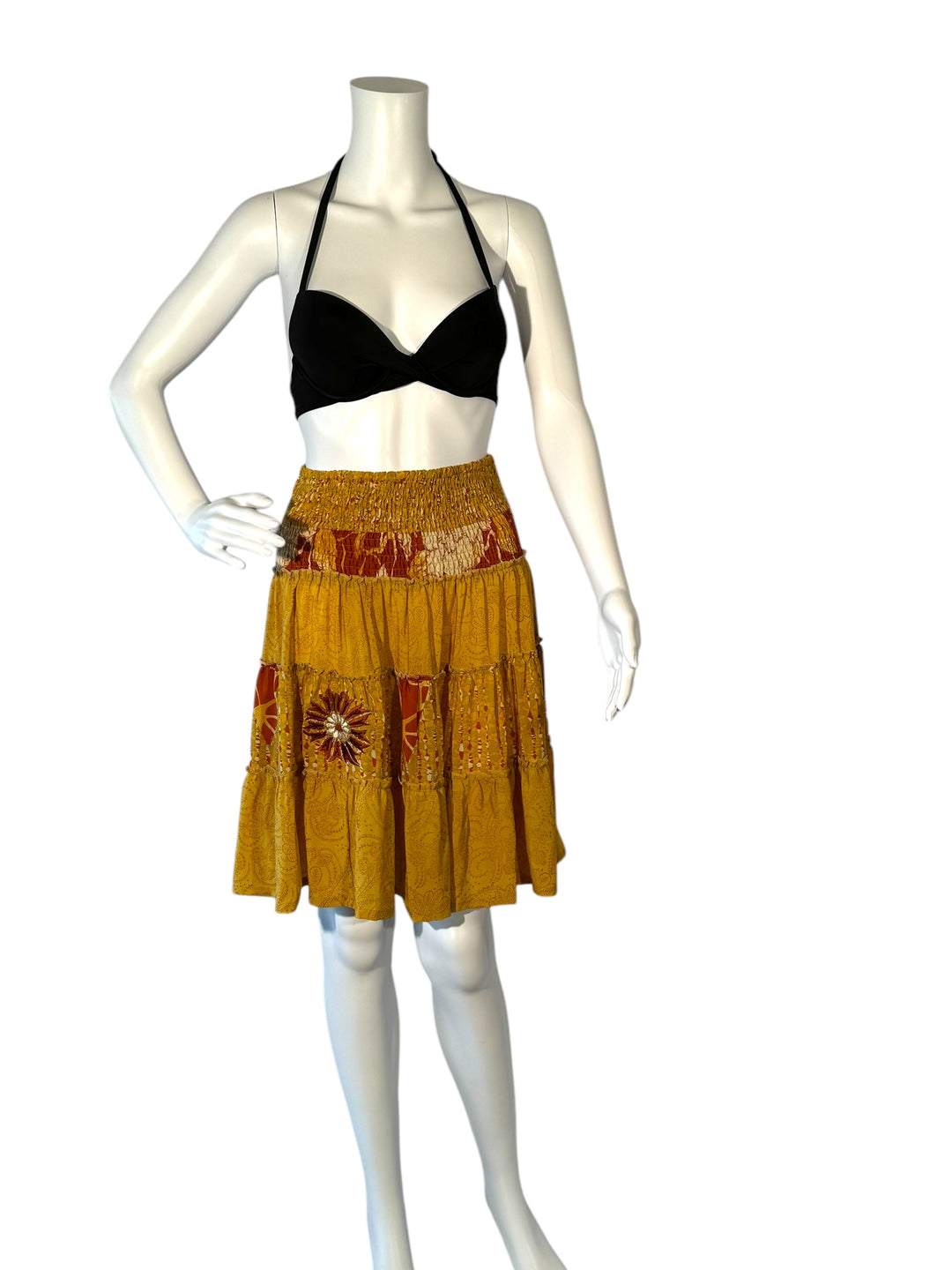 Mannequin wearing vintage silk gathered elastic short tiered skirt in gold with rush embroidered flowers