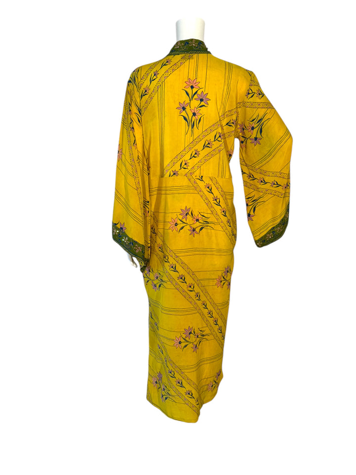 Back view of kimono in yellow vintage silk with green border prints and floral prints and gold embroidery