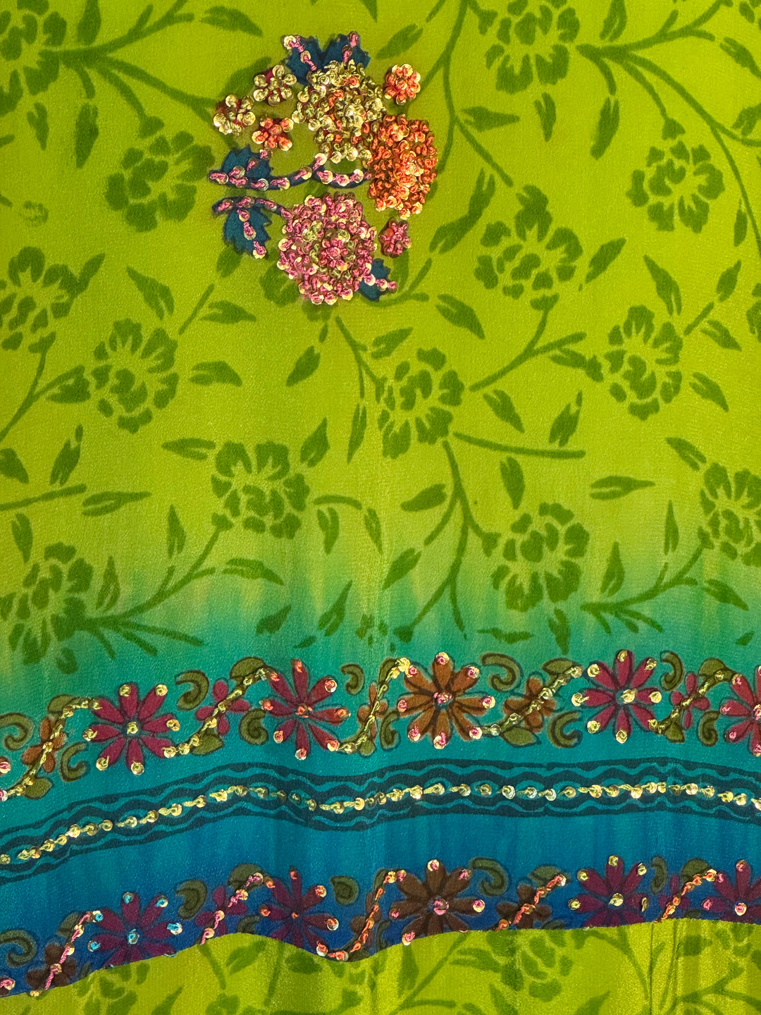 Bright green small floral print with blue border and colorful embroidery