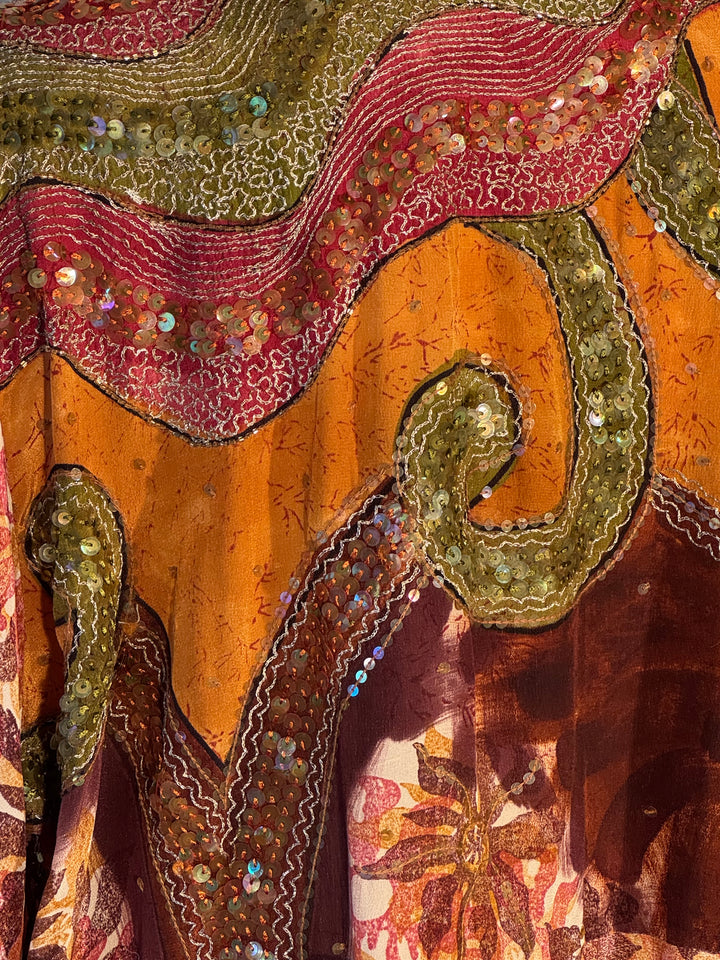 Richly patterned golden, red, yellow and embroidered vintage silk Iin swirls and flowers