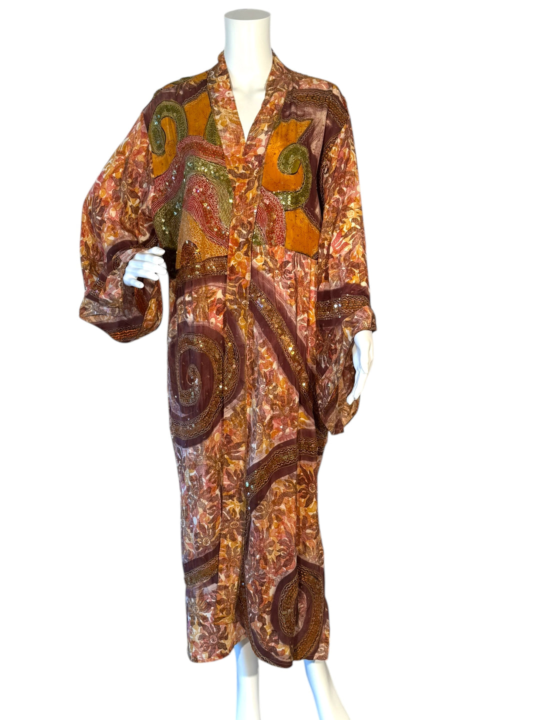 Front view of richly patterned golden, red, yellow and embroidered vintage silk kimono with large golden swirls