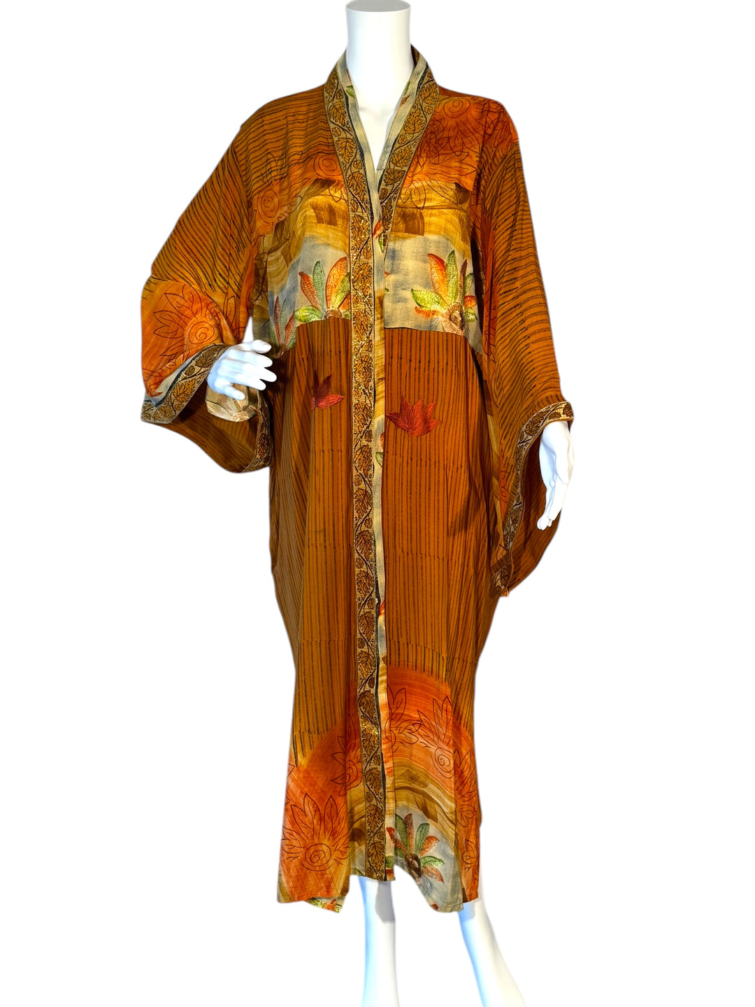 Front view of richly embroidered vintage silk kimono in orange and brown patterns with stripes and gold trim