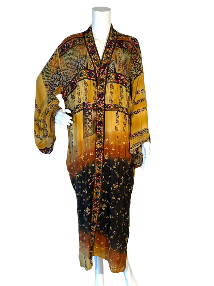 Front view of vintage silk kimono in black and yellow with multiple patterns and gold embroidery 