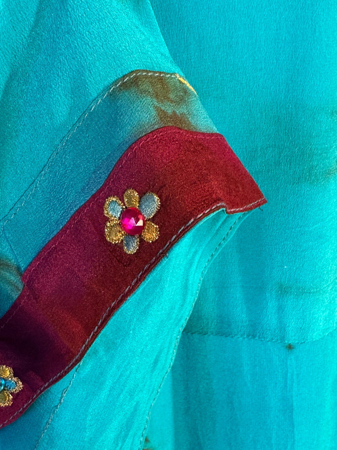 Sleeve detail of blue dip dyed vintage silk with dark red velvet trim and floral embroidery 